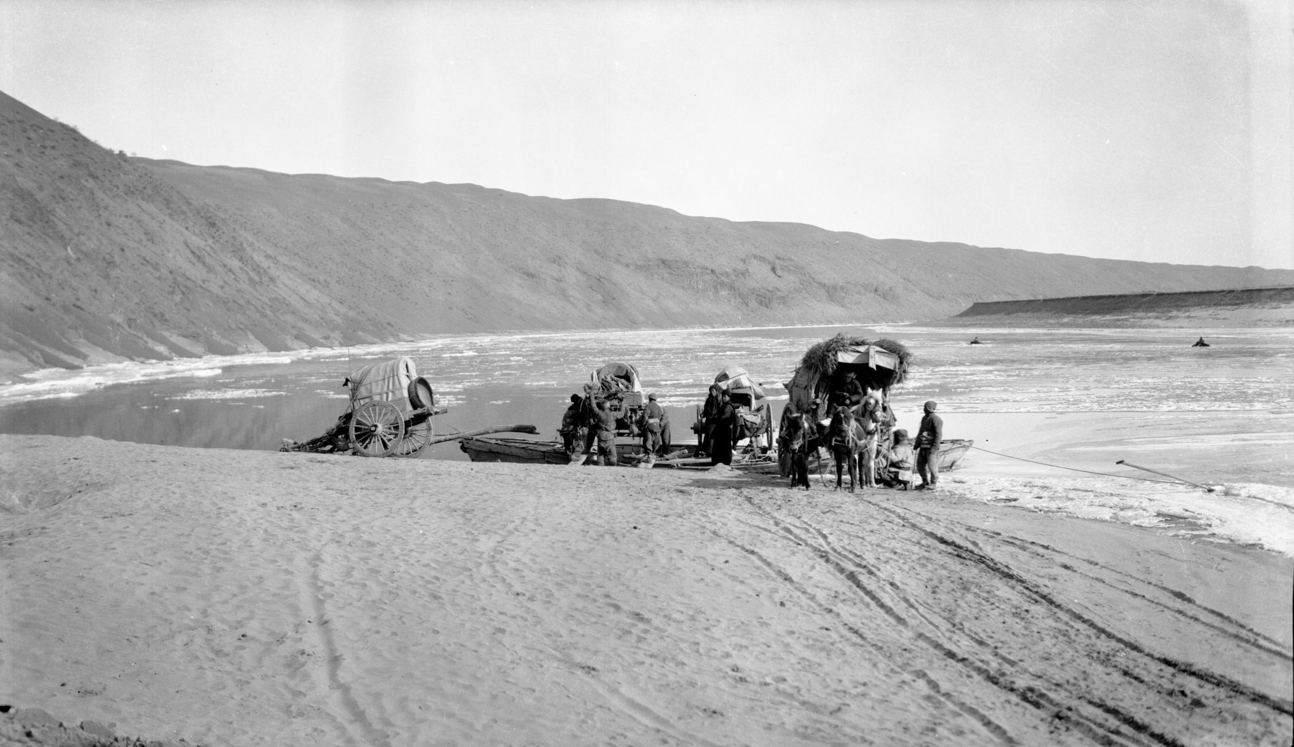 As the carts were boarding the ferry. Two coracles can also be seen crossing the river