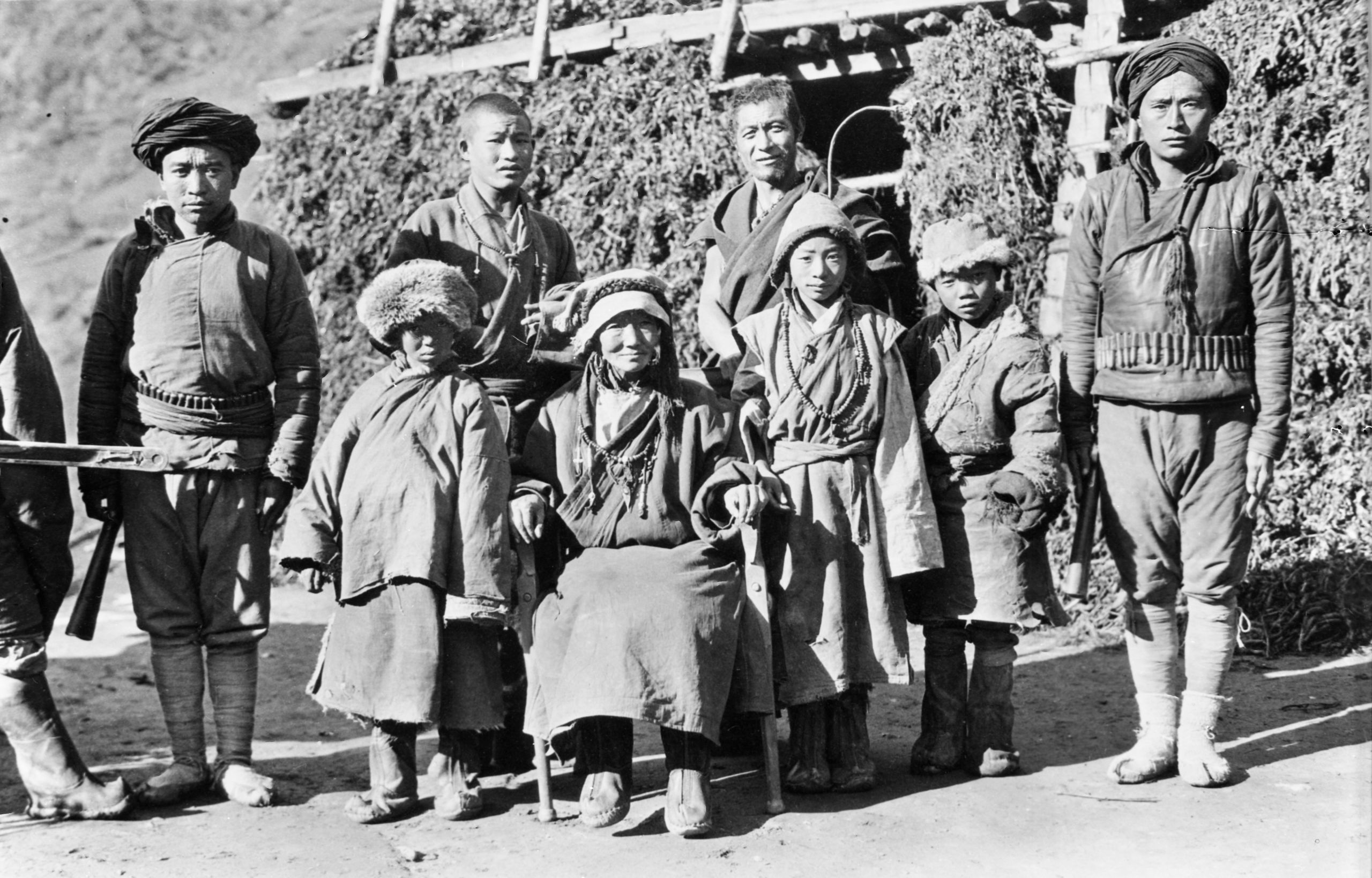 Portrait of the Headwoman and family at Tan Tu with her attendant Lamas