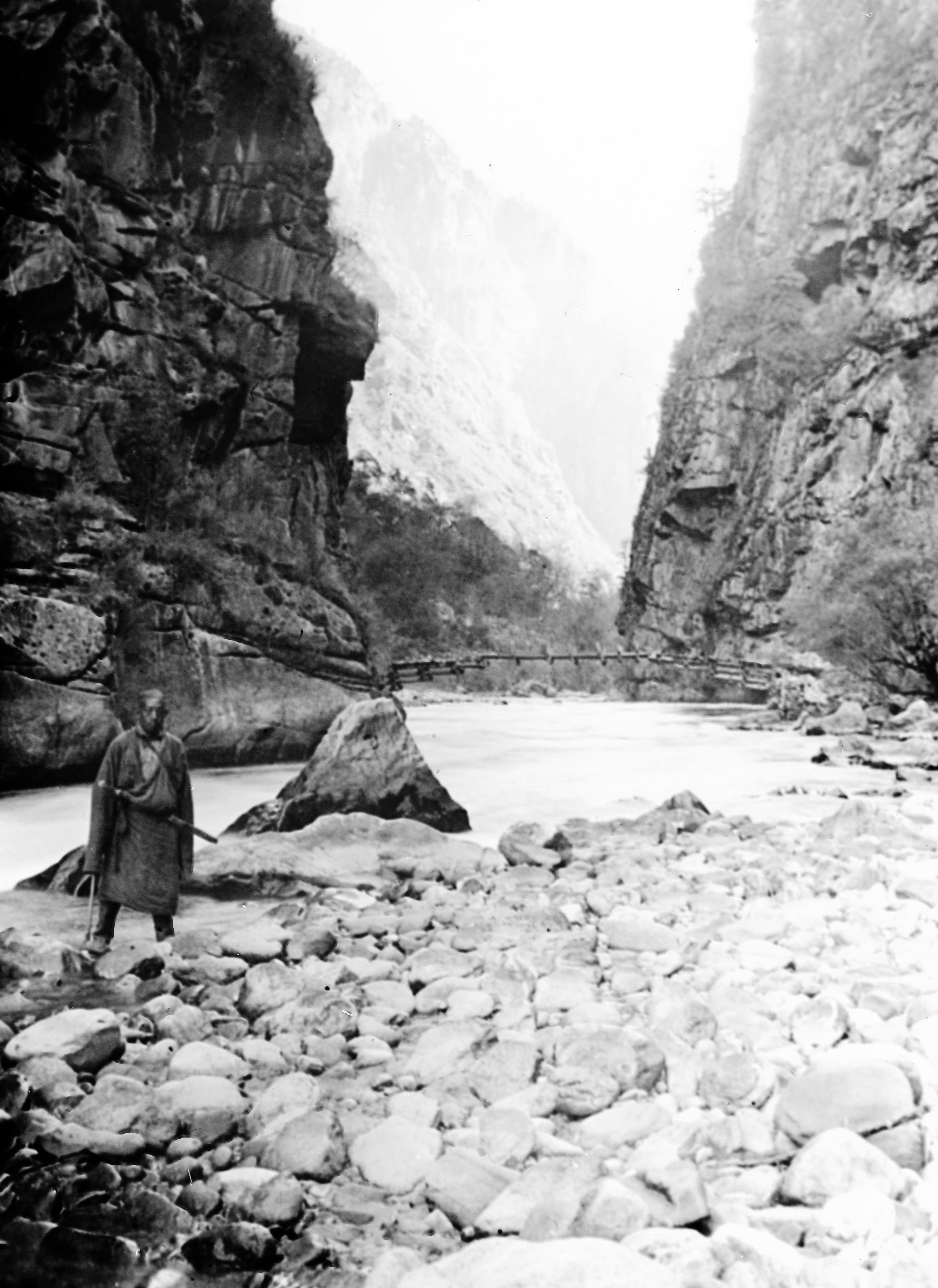 Picture from Lower down the river below Pi-erh showing the 'Mafoo on the rough road and the bridge in the background