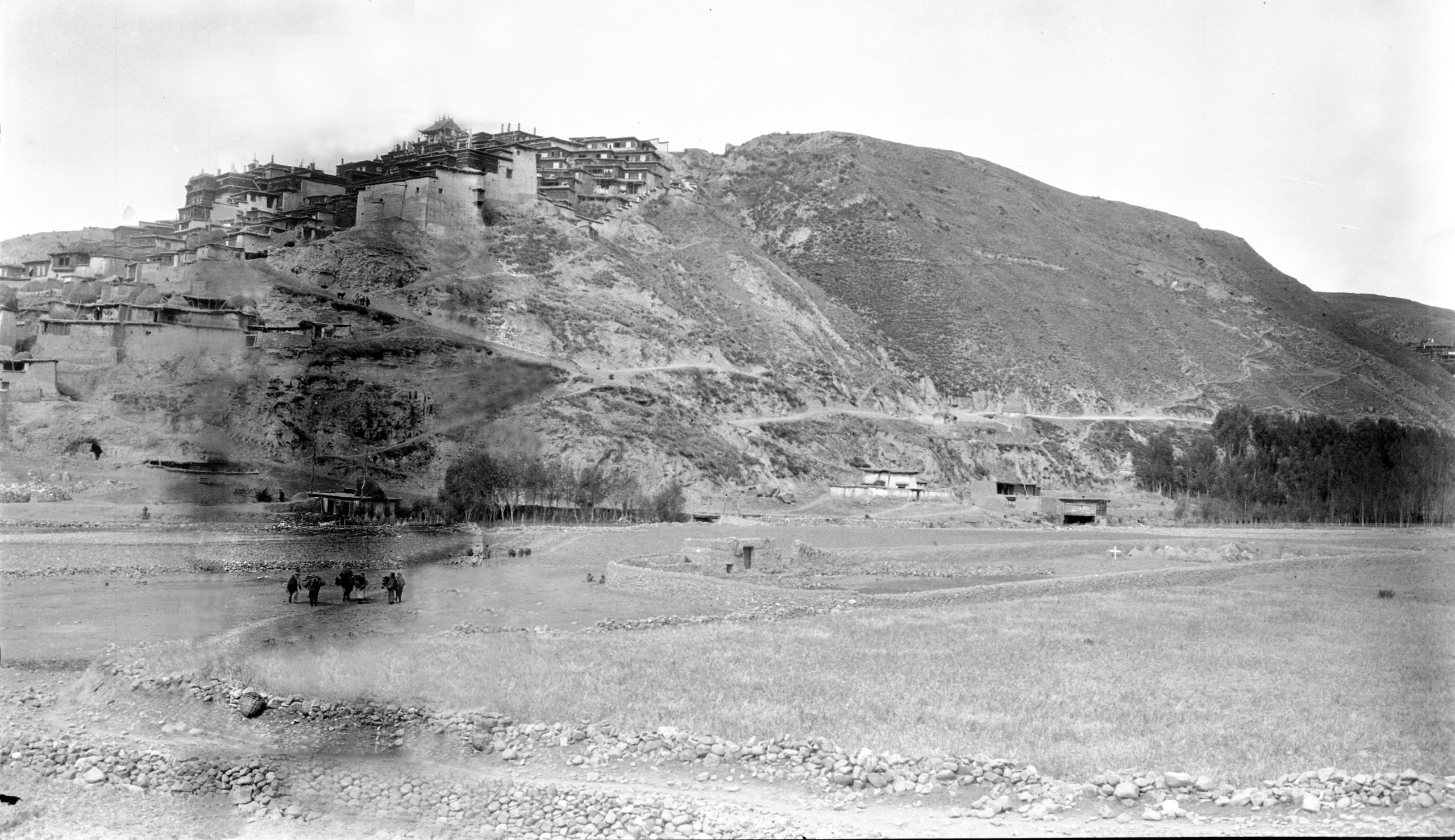Picture of The little cemetery under the shadow of the Lamasery at Kanze - grave marked with a cross