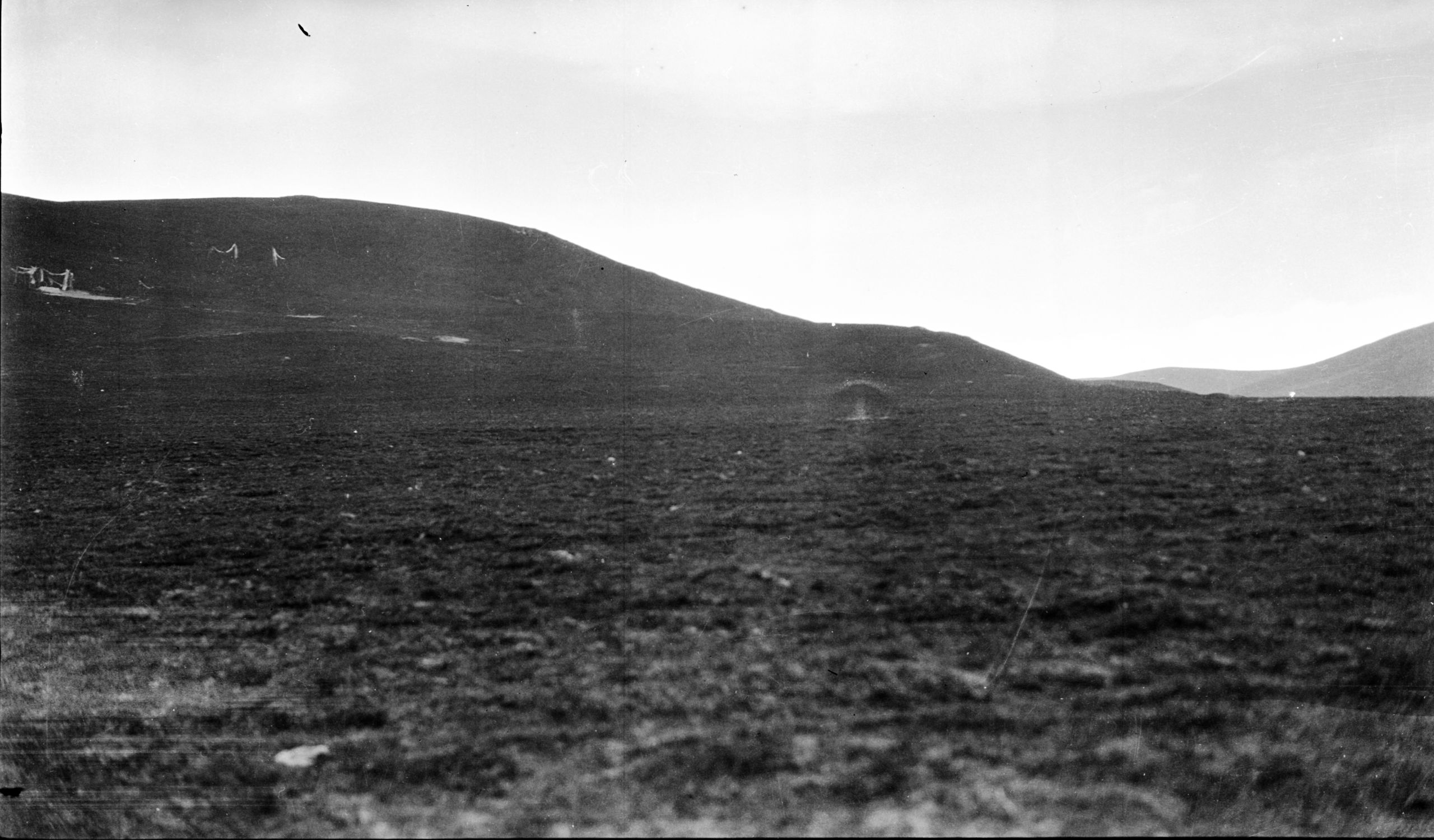 Picture of The landscape after leaving Rung-lung-la with a corpse on the hillside and a vulture flying overhead